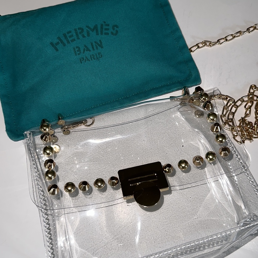 Hermès cosmetic bag authentic with a complimentary unbranded clear handbag